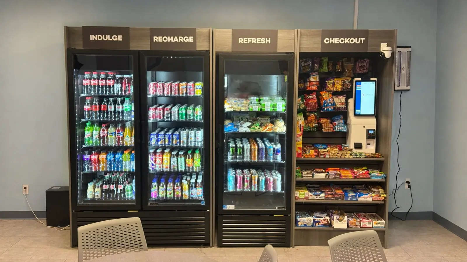 Four-section micro market with drink coolers and a checkout kiosk