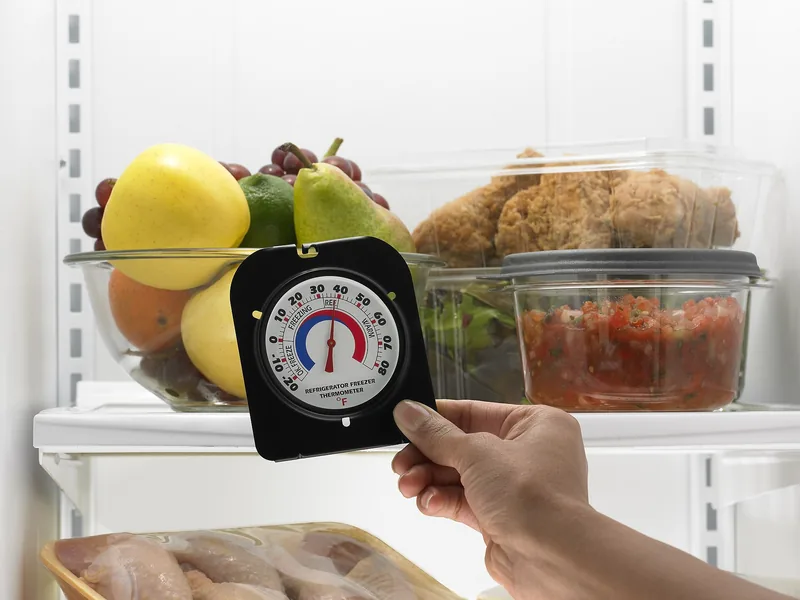 Thermometer placed inside a refrigerator to check that food stays at 40 degrees or below