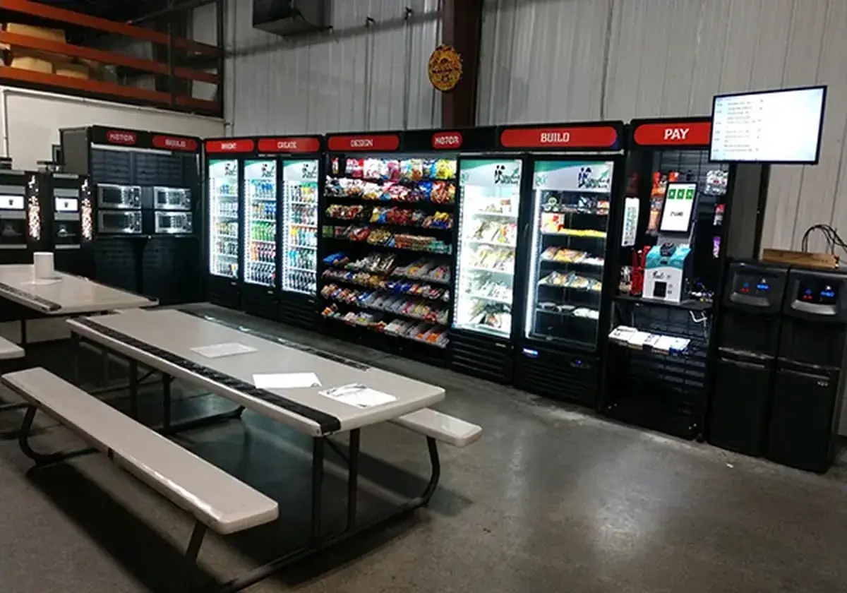 Long micro market wall with coolers next to a break area