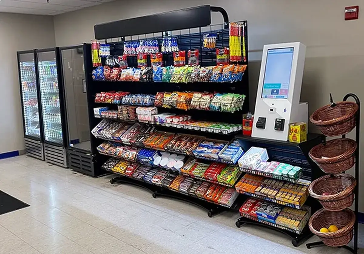 Micro market with snack racks, coolers and a kiosk