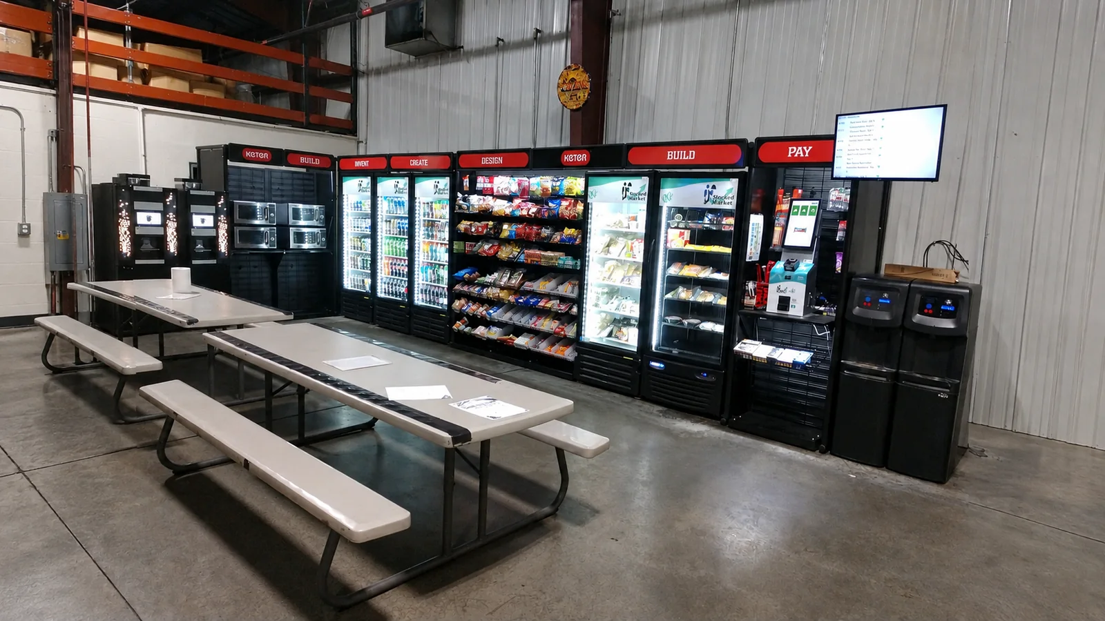 Warehouse micro market with coolers, snack racks, and microwaves