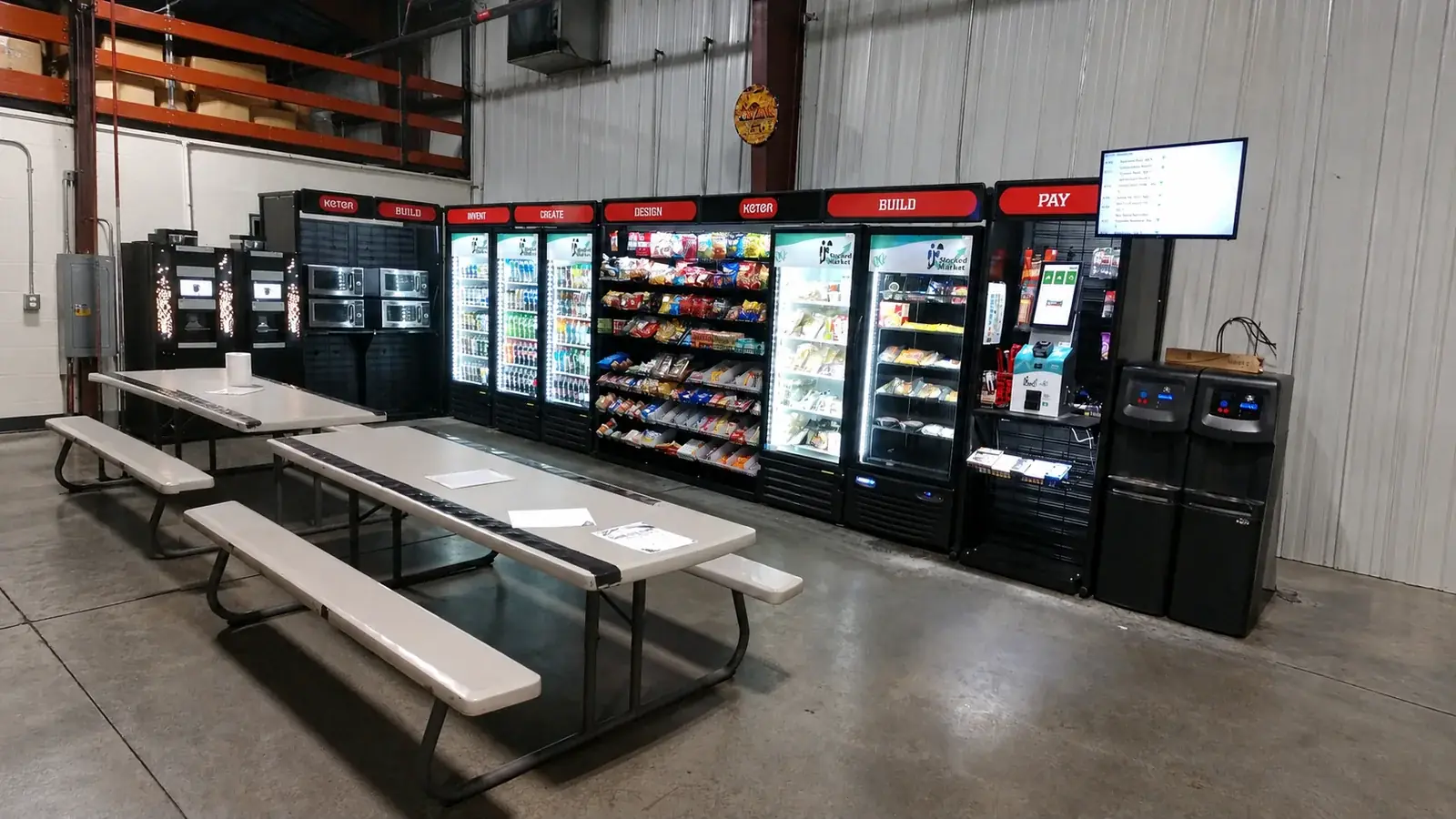 Warehouse micro market with coolers, snack racks, and microwaves