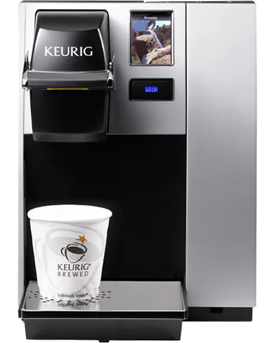 Keurig single-cup coffee brewing machine with paper cup under the dispenser.
