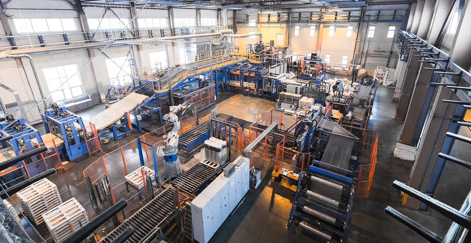 Large manufacturing facility with conveyors, automated machinery and industrial robots supporting Vendgo's micro market and smart cooler supply operations in Atlanta.